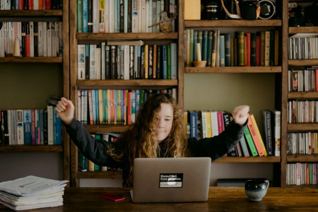 Photo by Annie Spratt woman in black long sleeve shirt sitting in front of silver macbook