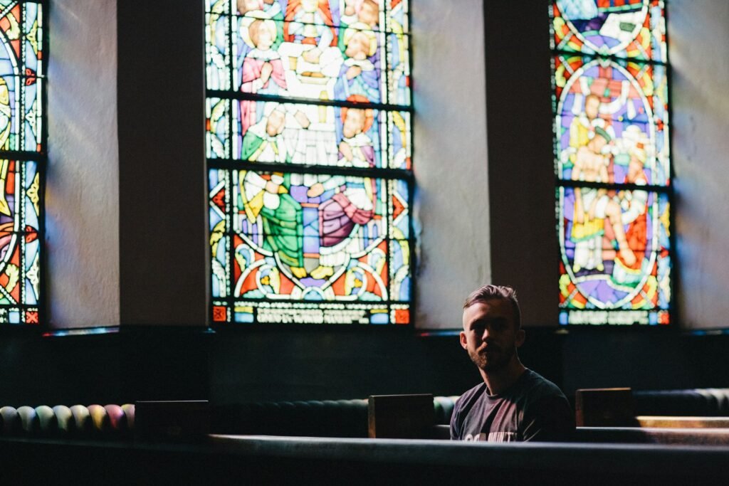 Photo by Karl Fredrickson man sitting on pew chair