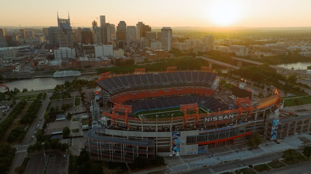 Photo by isaac macdonald an aerial view of a football stadium at sunset