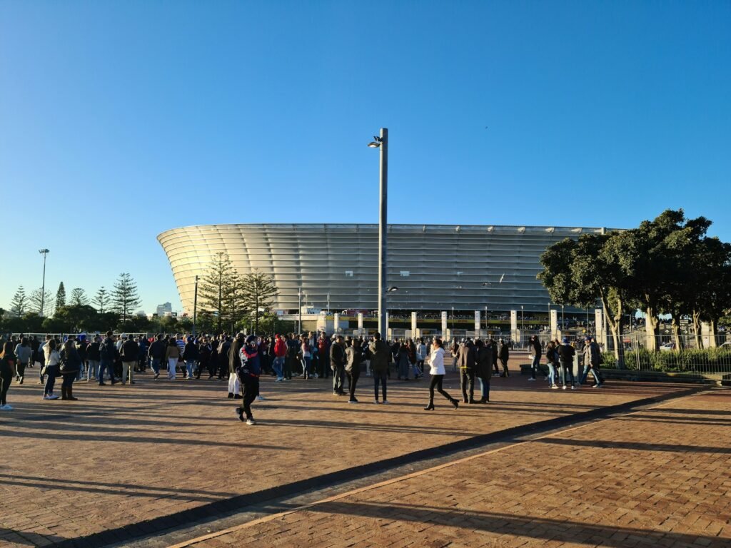 Photo by Delano Ramdas a crowd of people walking around a stadium