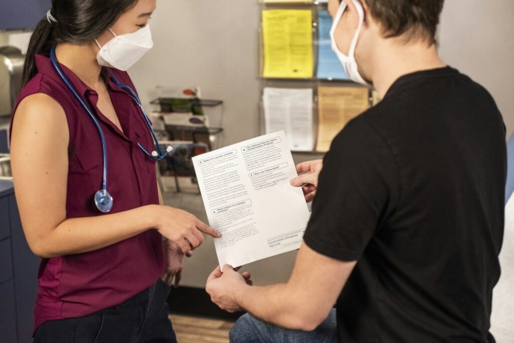 Photo by CDC woman in black shirt holding white printer paper