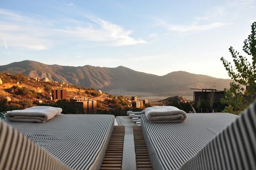 Photo by Manuel Moreno sunloungers fronting buildings near mountain